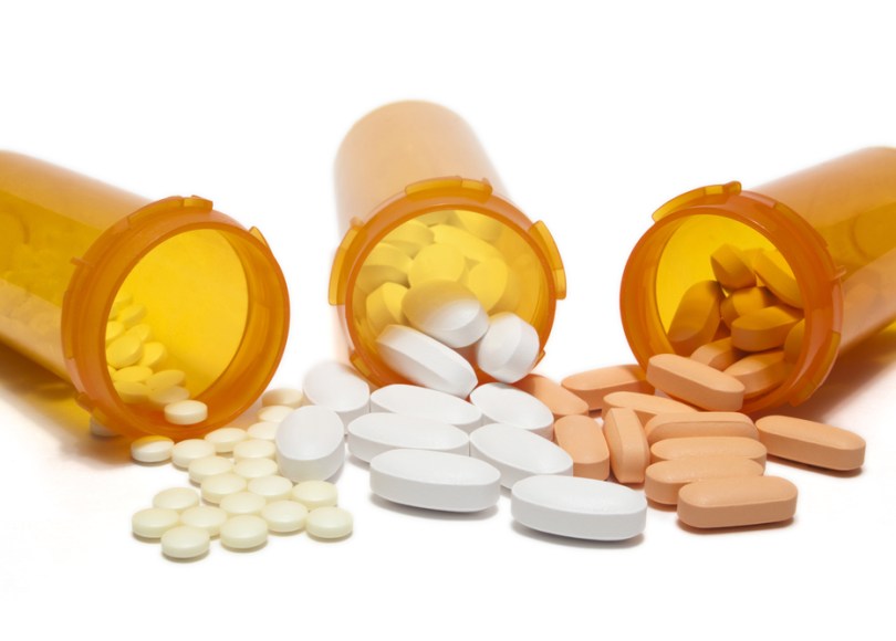 Three pill bottles spilling.