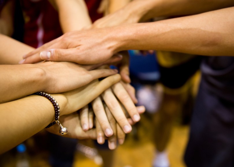 Mutual support shown by friends with their hands together