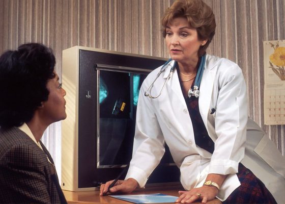 Patient having conversation with doctor about cancer treatment side effects